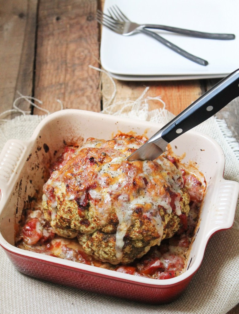 Whole Roasted Cauliflower with pesto and tomatoes via LizsHealthyTable.com